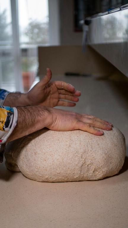 Pizza maker stretching the dough